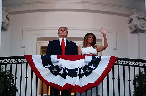 Donald and Melania Trump wave from the White House.